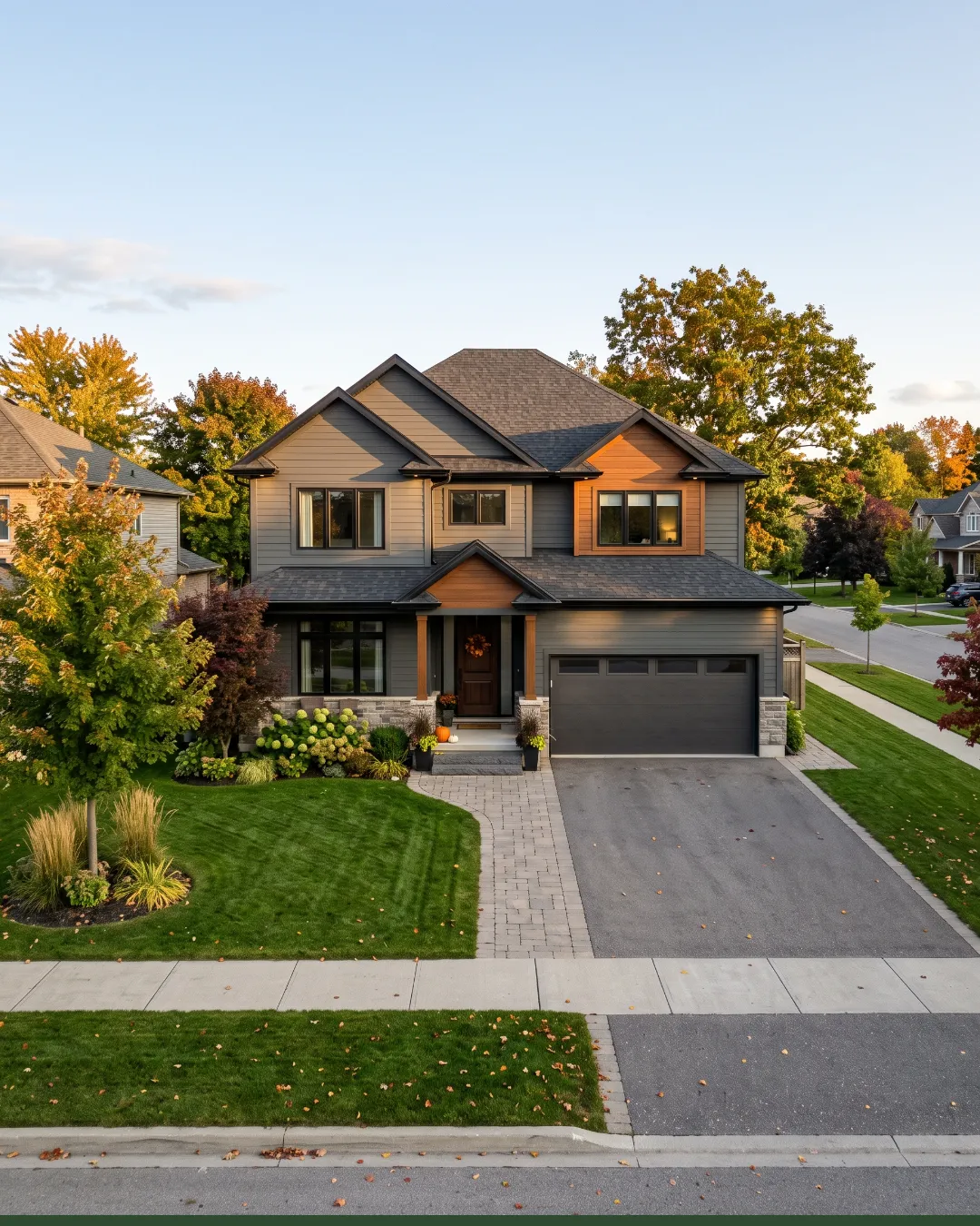 A large modern two-story home with a landscaped front yard